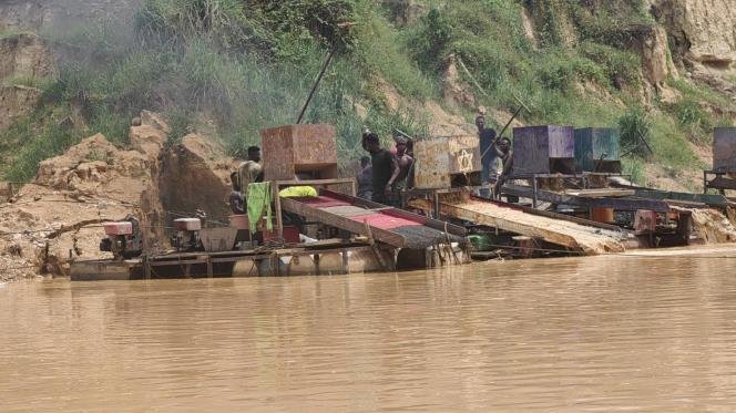 Illegal mining rigs on a silted river