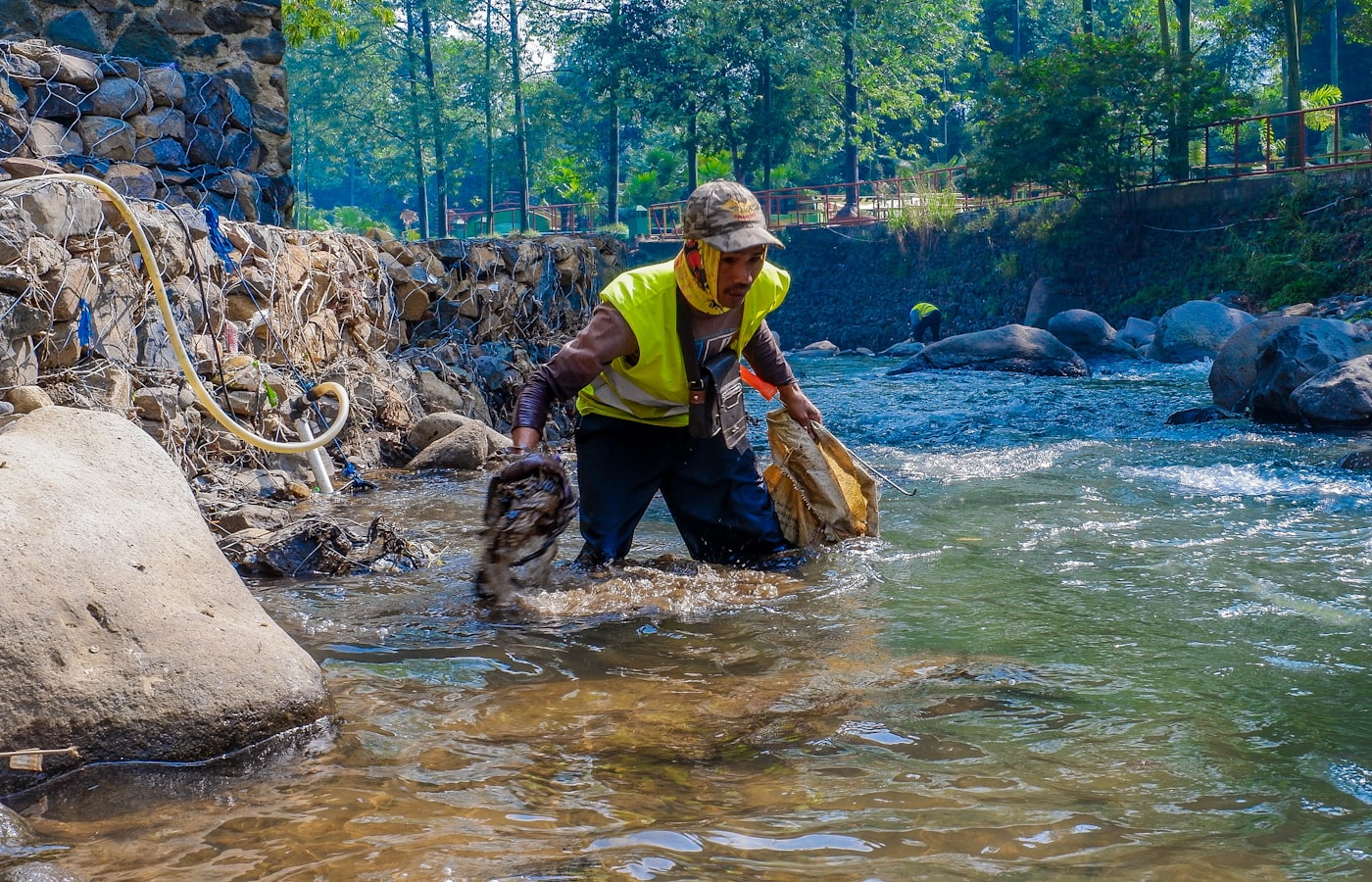 A miner working by hand in a river channel
