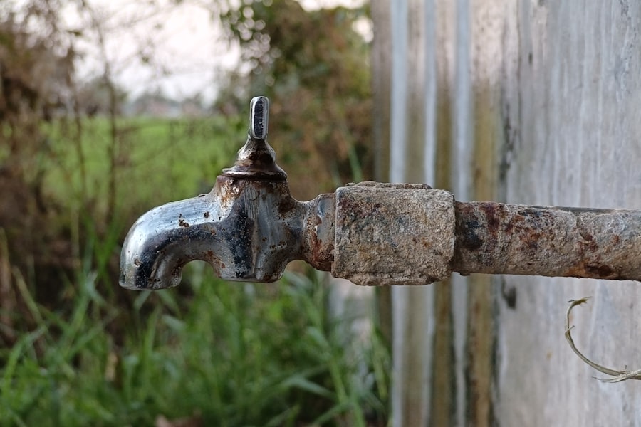 A rusted dry tap on a concrete wall