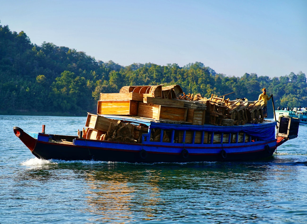 A cargo boat carrying goods along a waterway