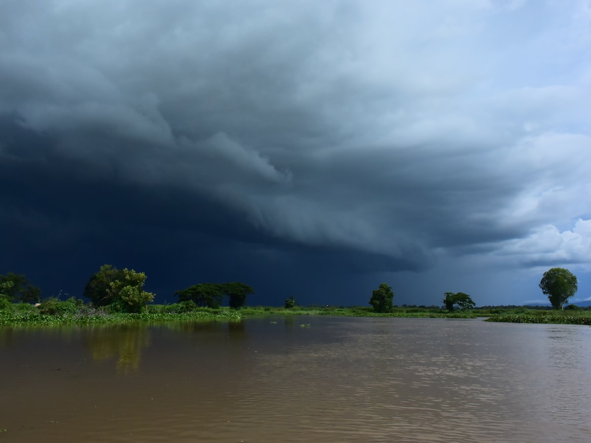 Storm clouds gathering over a flooded river landscape