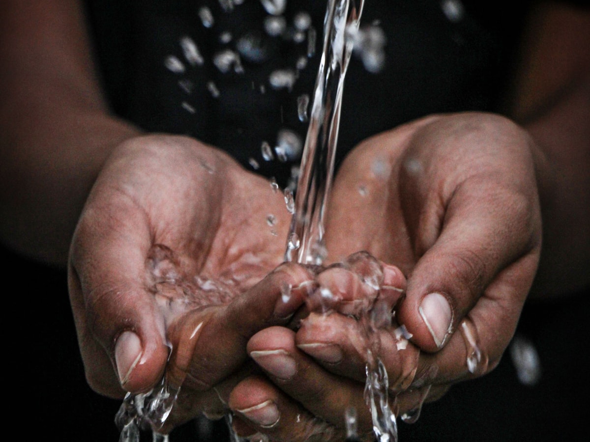 Clean water pouring into cupped hands
